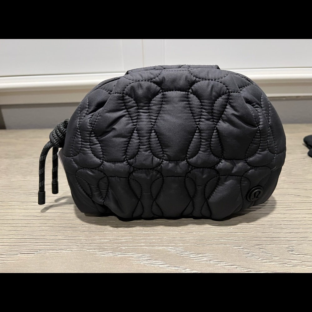 Brand new with tags. Black quilted embrace pouch.
